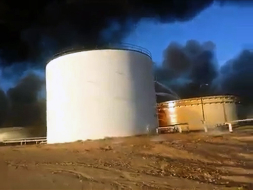 An image grab taken from a user generated content video uploaded on social networks on Tuesday shows a petroleum storage tank burning at Al Sidra oil terminal, near Ras Lanuf, in the so-called ‘oil crescent’ along Libya’s northern coast (AFP photo)